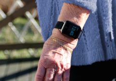 Sensorem's smart watch with security alarm for the elderly works when travelling, at the summer resort and abroad. Image of senior with smart watch